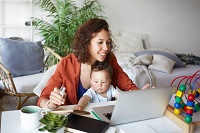 Woman with baby learning at home